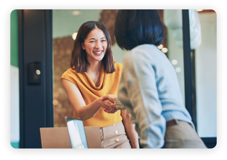 two businesswomen shaking hands